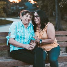 Two Women On A Bench Laughing